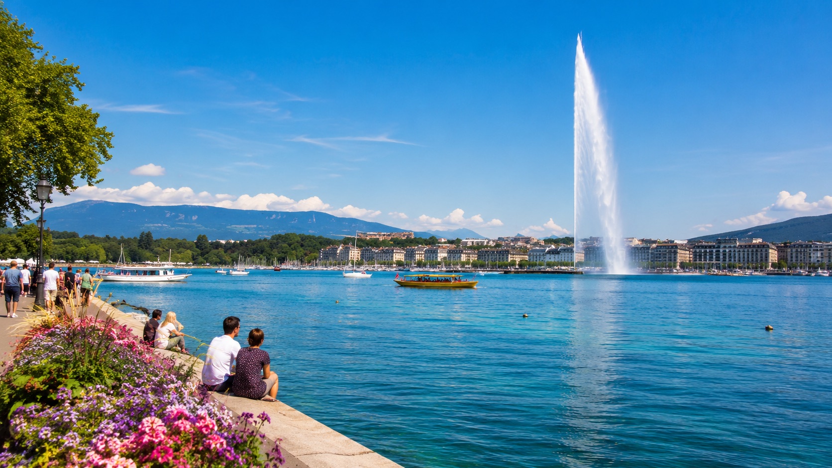 Summer view of Lake Geneva and the Jet d'Eau with people relaxing by the water in Geneva, Switzerland